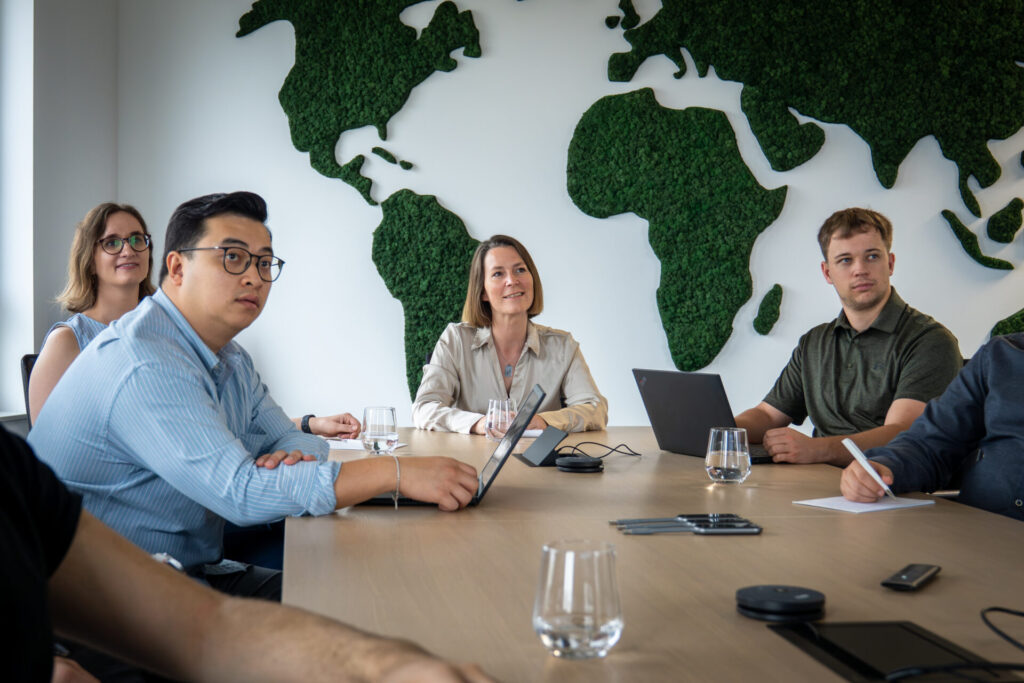Advancis colleagues talking around a desk